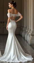 : Luxury satin bridal gown with an open-back lace-up design, off-shoulder lace sleeves, and a lace-trimmed mermaid train – perfect for an enchanting wedding day look. | فستان زفاف مكشوف الظهر مع أكمام دانتيل وتصميم فاخر بذيل طويل مزين بالدانتيل | Vestido de novia con espalda descubierta y detalles en encaje – un look nupcial sofisticado y chic. | Robe de mariée dos nu en satin avec détails en dentelle et traîne élégante – parfaite pour une cérémonie majestueuse.